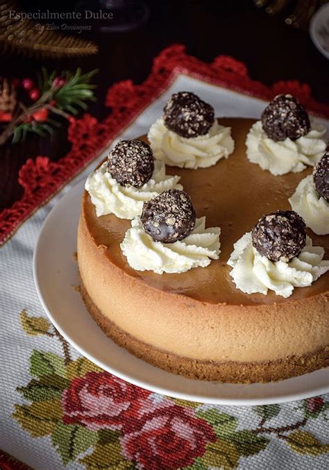 A Cake With White Frosting And Chocolate Balls On Top Is Sitting On A Plate