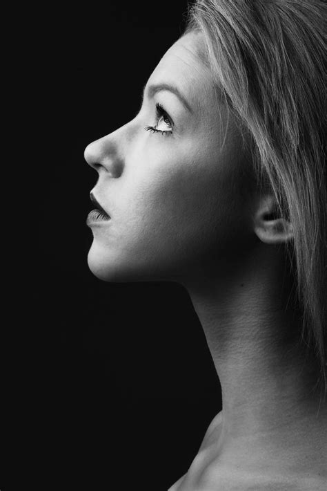 a black and white photo of a woman s profile with her eyes closed to the side