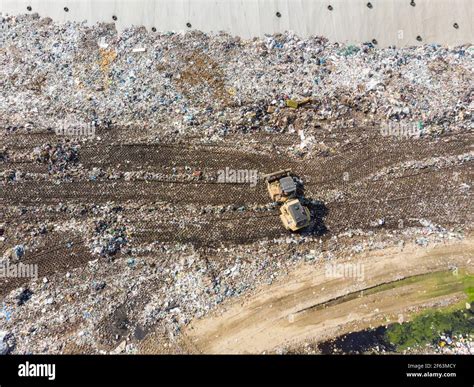 Garbage Trucks Unload Garbage To A Landfill Stock Photo Alamy