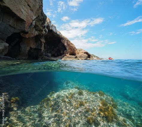 Cave On The Sea Shore With Rocky Bottom Underwater Split View Above