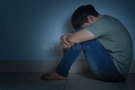 Sad Man Hug His Knee And Cry Sitting Alone In A Dark Room Depression