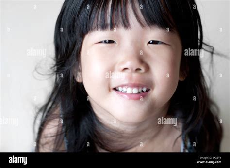 Portrait Of Single Eyelid Little Asian Girl Smiling Looking Up Stock