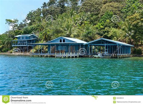 Caribbean Home And Boat House Over The Water Stock Photo
