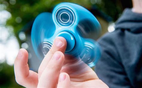 You don't have to be a pro athlete to do all the tricks that come with fidget spinning. SBS Guide to: Fidget Spinners - ScoreBoredSports