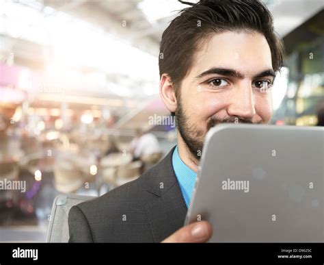 Portrait Of Young Businessman Using Digital Tablet Smiling Stock Photo