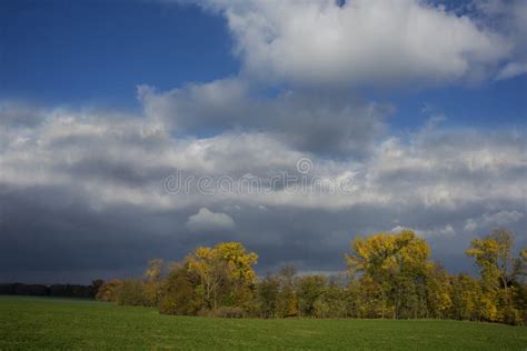 Stormy Dark Clouds Over The Trees And Field The Fall Scene Stock