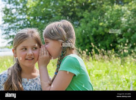 Girl Whispering In Another Girls Ear Hi Res Stock Photography And