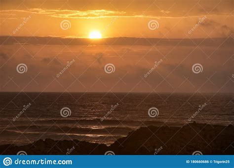 Beautiful Orange Sunset Over The Sea And Rocks Stock Photo Image Of
