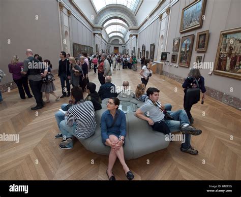 Interior Of Corridor Full Of Tourists In The Louvre Museum In Paris