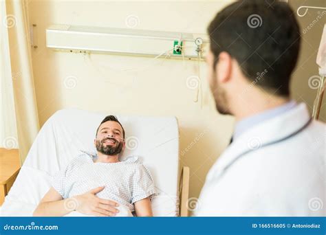 Man Listening To Medical Professional In Hospital Stock Image Image