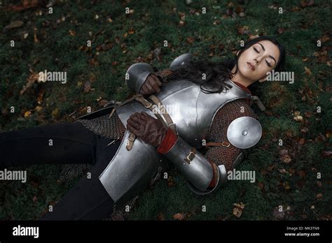 A Beautiful Warrior Girl Wearing Chainmail And Armor Lying On The