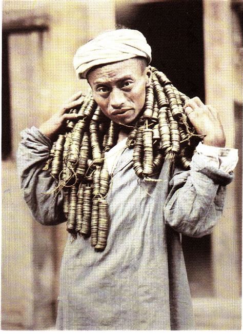 An Old Photo Of A Man With Many Beads On His Head