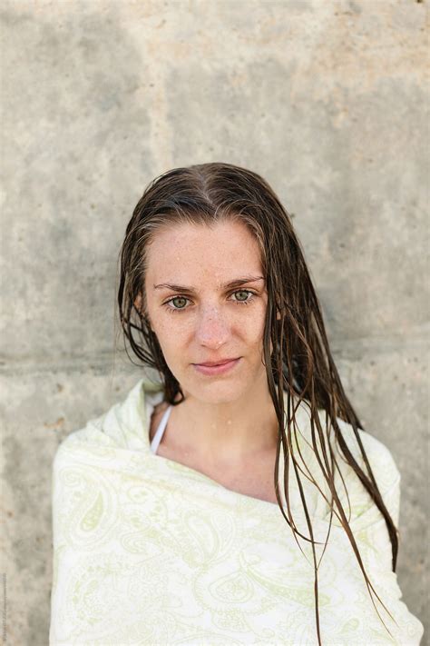 Portrait Of A Young Woman With Wet Hair Covered With A Towel Outdoors By Stocksy Contributor