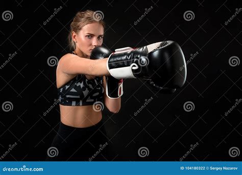 Beautiful Female Athlete In Boxing Gloves In The Studio On A Black