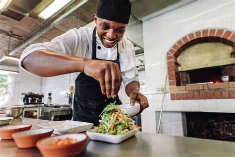 Male Chef Preparing Salad In Kitchen Gourmet Chef Making Delicious Dish In Restaurant Kitchen