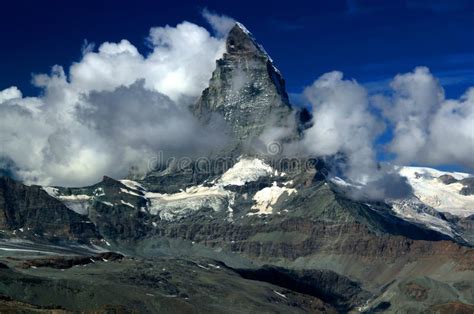 A Mountain Matterhorn View Partially Covered By Clouds On A Mountain