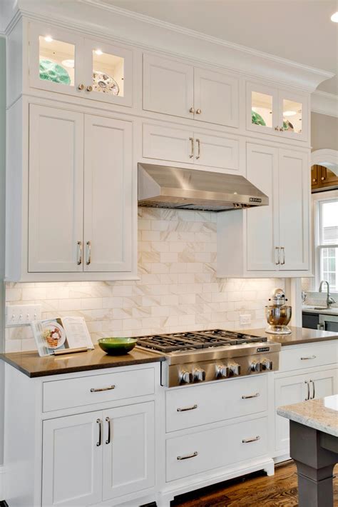 Backsplash running all the way up to the cabinets (about 18 inches). White Shaker Cabinets Pair With Marble Kitchen Backsplash | HGTV