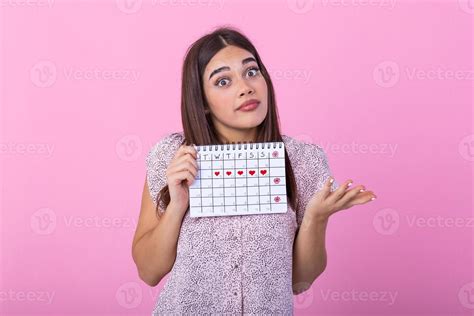 Portrait Of Young Woman In Dress Holding Female Periods Calendar For