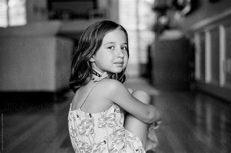 Black And White Portrait Of A Beautiful Young Girl Looking Back At The Camera By Stocksy