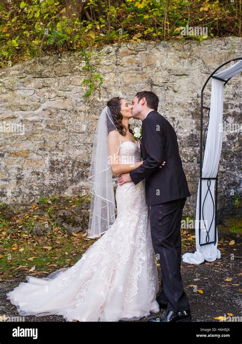 Bride And Groom Kiss During Wedding Vows Outdoor Garden Ceremony Omni