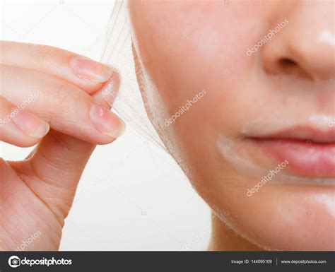 Woman Removing Facial Peel Off Mask Closeup Stock Photo By ©voyagerix