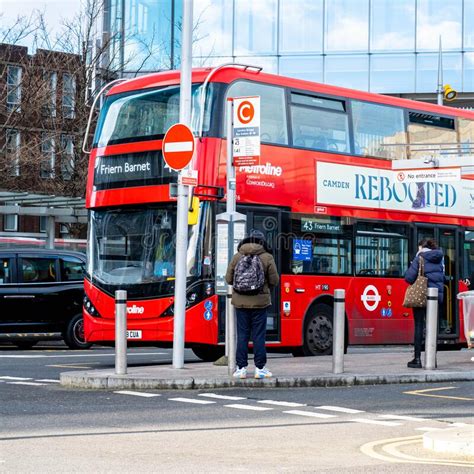 Red Double Decker London Bus Picking Up Passengers At Bus Stop In Central London Editorial Stock