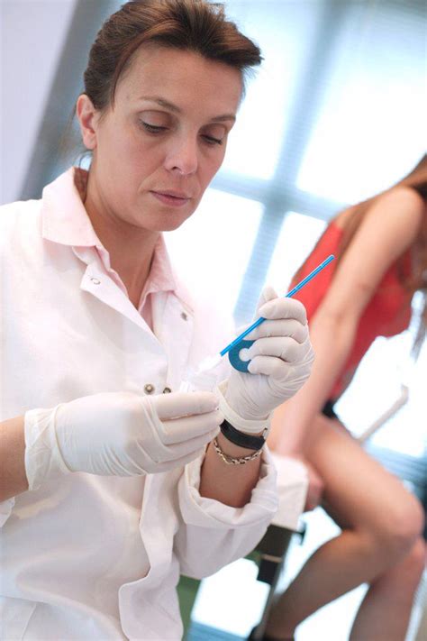 Gynecologist Performing A Cervical Smear Or Pap Test On A Teenage Patient Superstock