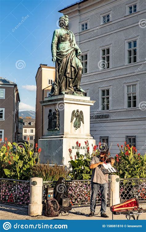 Violinist Plays In Front Of The Statue Of Wolfgang Amadeus