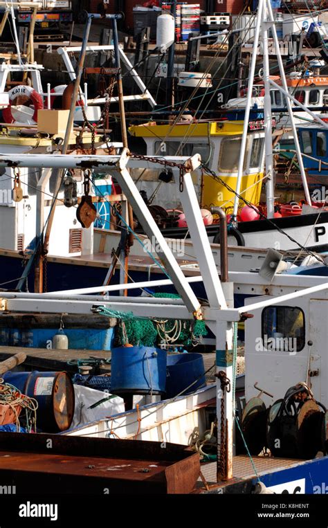 Fishing Boats And Trawlers Together In A Packed And Busy Fisherman Dock