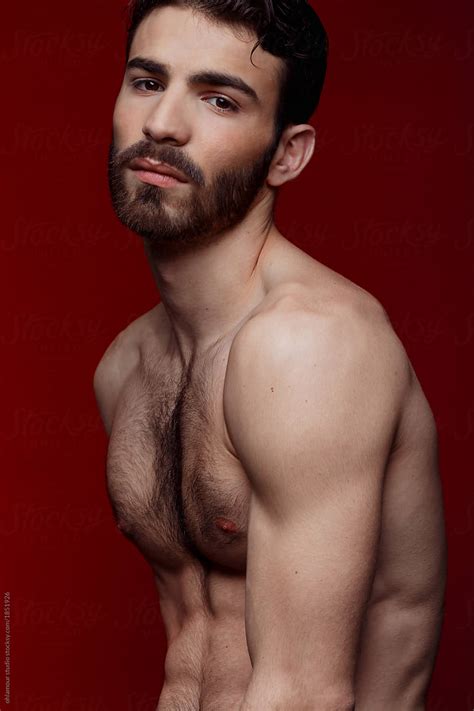 Handsome Shirtless Strong Man Portrait Over Red Background By Stocksy Contributor Ohlamour