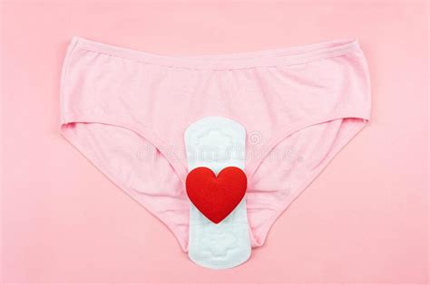 top view white sanitary napkin red heart and pink underpants isolated on pink background woman