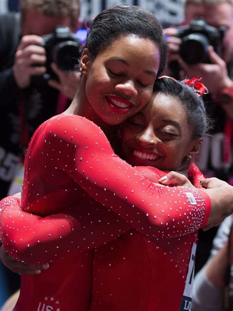 Usas Simone Biles Right Celebrates Winning The Gold Medal With Teammate Gabby Douglas Who