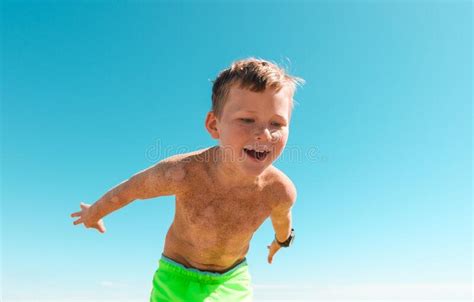 Smiling Happy Kid In Sand Playing Child Boy Playing In The Sea Kid
