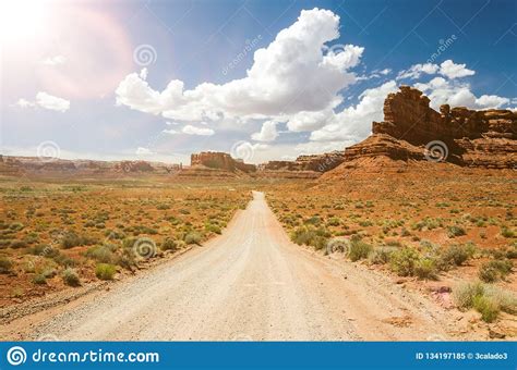 Dirt Road In Scenic Desert Landscape With Lens Flare Stock Image