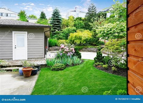 Nice Back Yard Landscape Desing With Well Kept Lawn Stock Photo