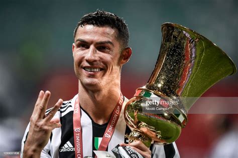Cristiano Ronaldo Of Juventus Fc Celebrates With The Trophy During