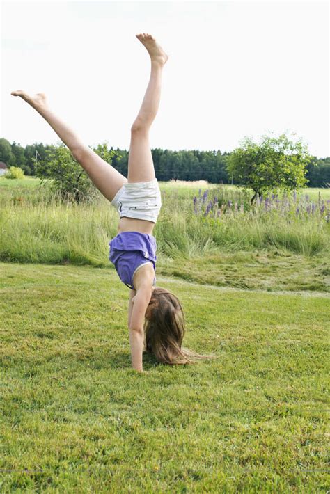 Girl Doing Cartwheel Stock Photo