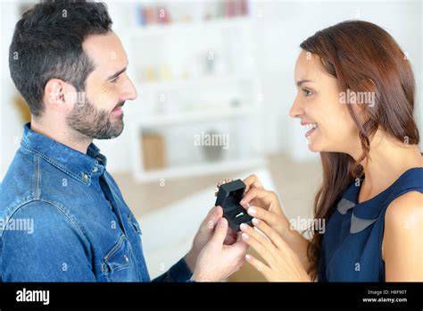 Woman Accepting Ring From Man Stock Photo Alamy