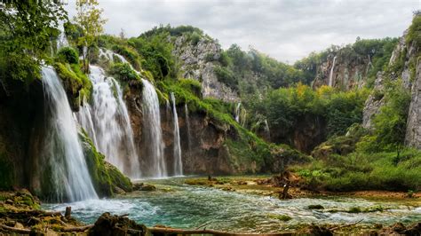 Beautiful Waterfalls Pouring On River Greenery Rock Mountains Bushes