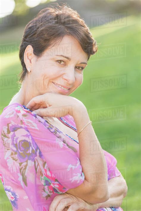 Portrait Of Mature Woman Smiling Outdoors Stock Photo Dissolve