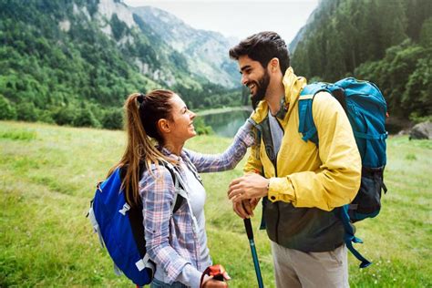 Happy Couple Smiling Outdoors On Hiking Trip Young Couple Enjoying