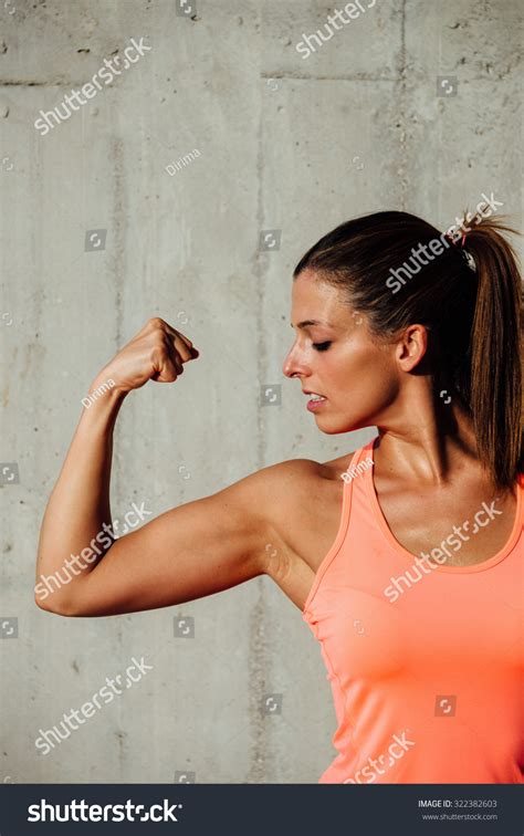 Strong Fit Woman Flexing Arm Biceps Stock Photo 322382603