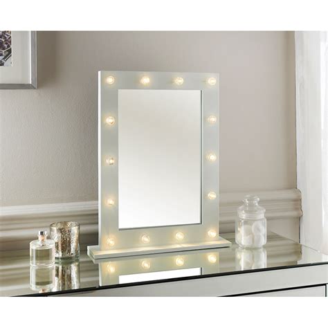 With its neutral beige coloring and exotic design, it features 2 nubuck leather drawers, 1 top secret door and a sturdy and sleek metal base. Hollywood Dressing Table Mirror | Decorative Mirrors - B&M