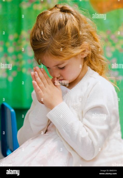 A Young Girl Bowing Her Head In Prayer Stock Photo Alamy