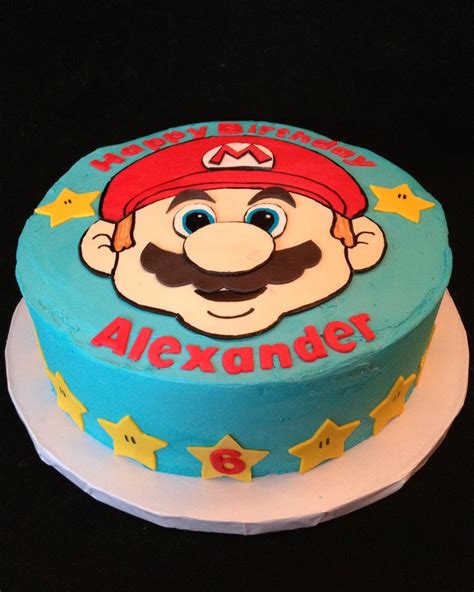 Sponge with a layer of raspberry jam and sweet filling, covered with soft icing and finished with edible decorations. Alexander's Super Mario Cake