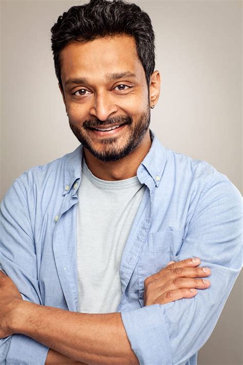 Bearded Indian Actor In Smiling Headshot Wearing Casual Shirts And Arms