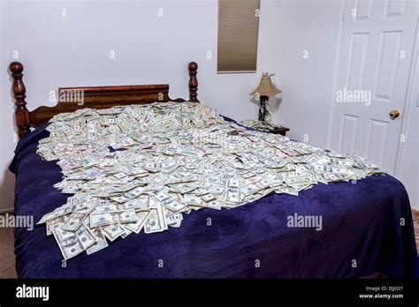 A Bed Covered In Piles Of American Money Stock Photo Alamy