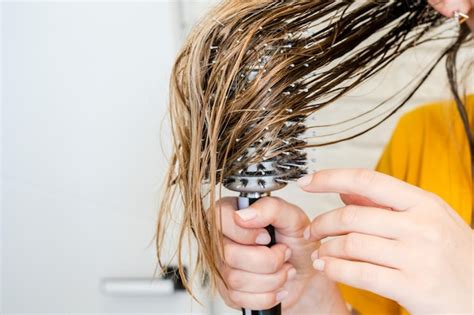 Premium Photo Woman Combs Her Wet Hair Hair Brushing