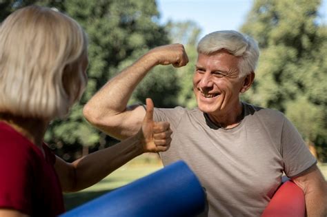 premium photo smiley older couple outdoors with yoga mats