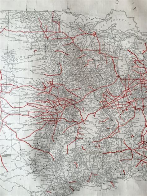 An Old Map With Red Lines In The Middle And On Its Sides Showing Roads